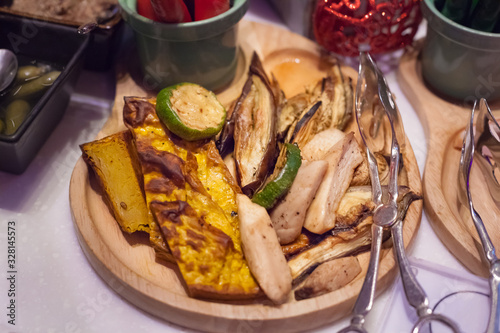 Arabic Halal Vegan Mixed Grill Mushroom, Eggplant, Pumpkin, Artichoke. Barbecue Vegetables on wooden tray background. Islamic and Vegetarian Cuisine. Food Catering, Healthy Food and Nutrition concept