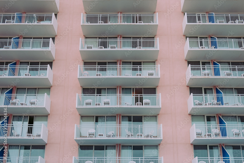 Outside view of a pink hotel covered with balconies. Outside view of a pink hotel covered with balconies.
