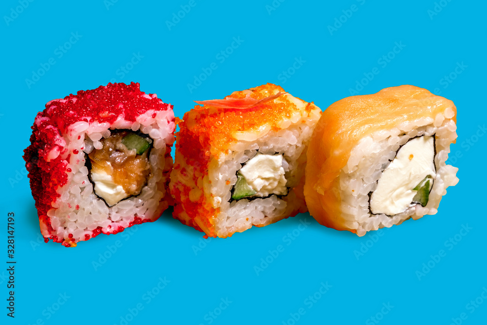 A set of sushi neatly arranged on a blue background A set of sushi neatly arranged on a blue background