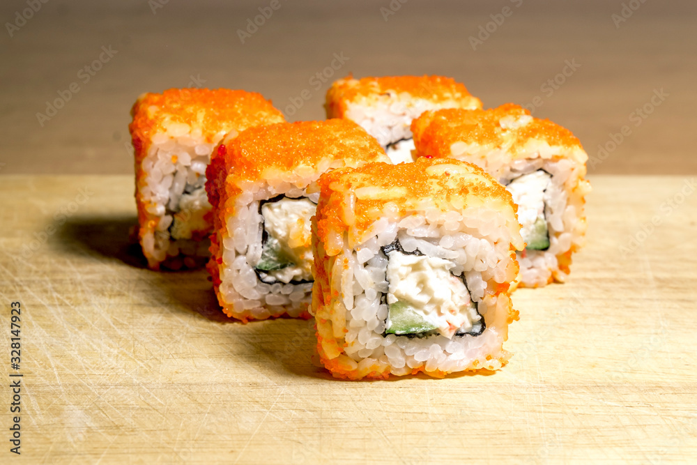 A set of sushi neatly laid out on a wooden surface A set of sushi neatly laid out on a wooden surface