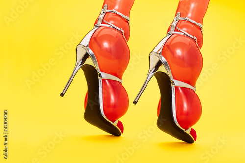 Close up of orange inflated balloons in stilettos photo