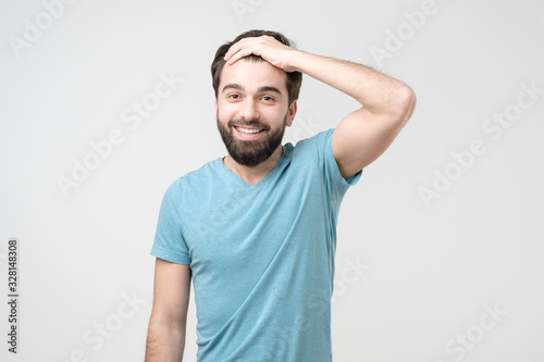 Guy with beard holding hand on head glad that he remember important thing