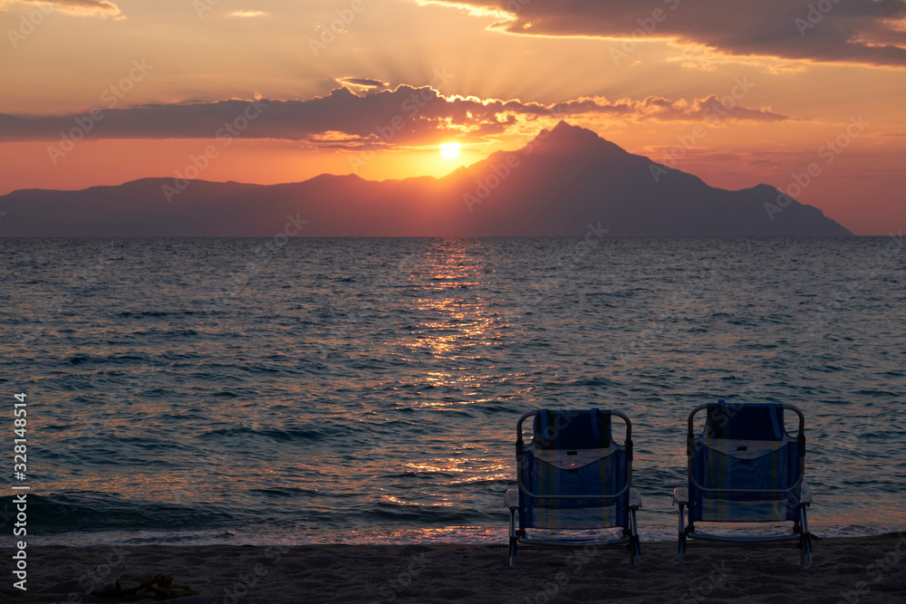 Empty lounge chairs on sunset Empty lounge chairs on sunset
