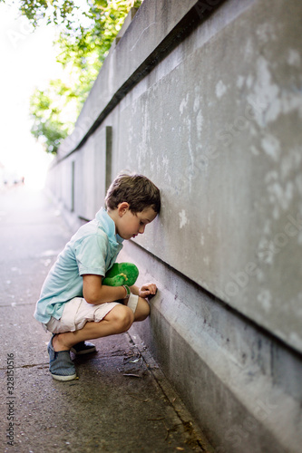 Boy having a meltdown moment on a footpath photo