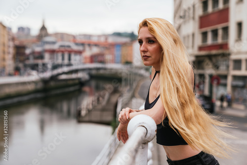 Side view of Blonde long hair woman with make up enjoying the vi photo