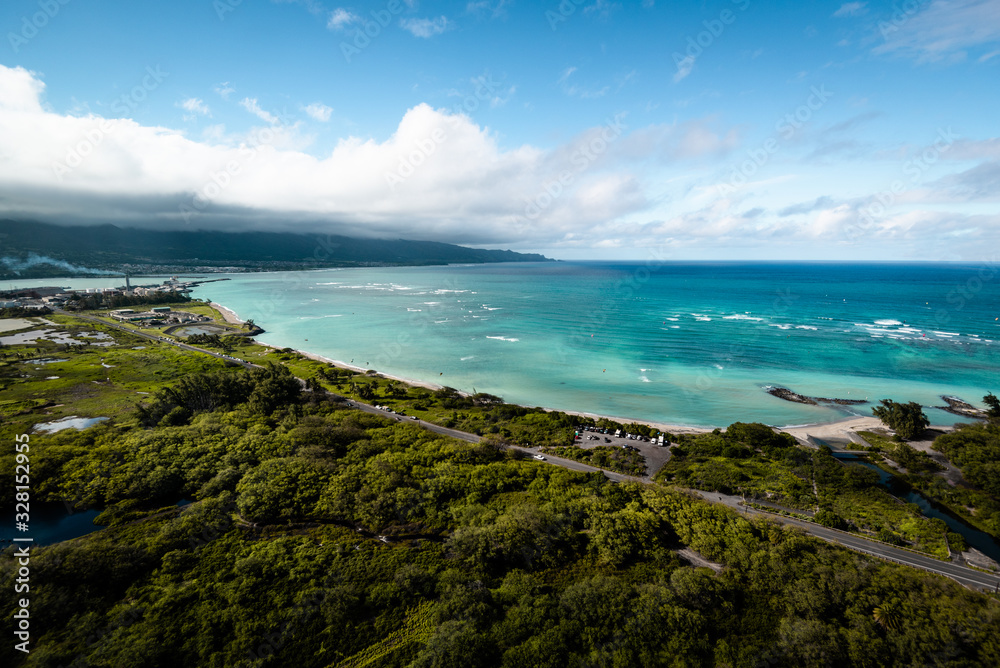 Hawaiian Island Beach Scene Aerial Landscape View of Beautiful Tropical Island Paradise with Clear Aqua Blue Water, Green Forest, and White Sand Beach on Perfect Clear Sunny Day in Maui Hawaii