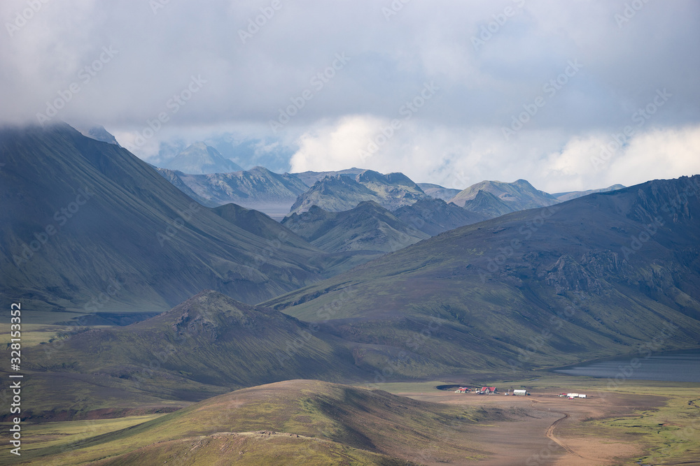View on Hvanngil mountain hut and camp site with green hills, river stream and lake. Laugavegur hiking trail, Iceland