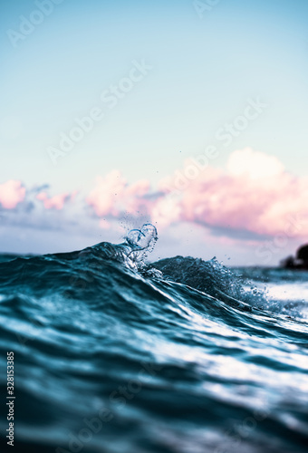 Beautiful Phenomenon of Clear Blue Wave Breaking Creating Heart Shaped Splash with Colorful Sunset Sky in Scenic Background in Tranquil Tropical Island Paradise Nature Scene of Maui Hawaii