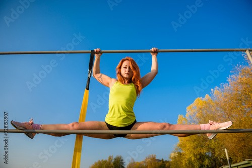 Beautiful woman doing split on a warm summer day. sport active lifestyle concept