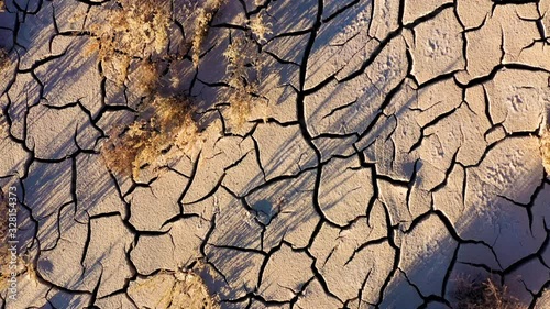 Looking down at the cracked surface of a dry river photo