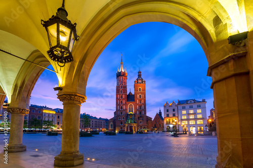 Basilica of Saint Mary on Medieval Main market square as seen from Krakow Cloth Halt at sunset, Krakow, Poland