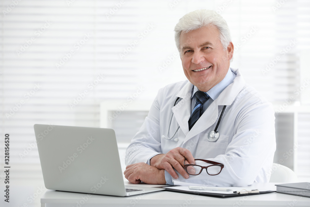 Portrait of senior doctor in white coat at workplace Portrait of senior doctor in white coat at workplace