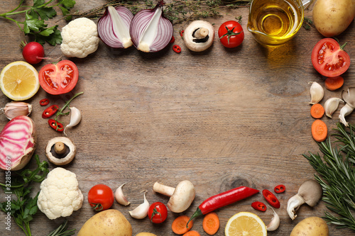 Flat lay composition with fresh products on wooden table, space for text. Healthy cooking