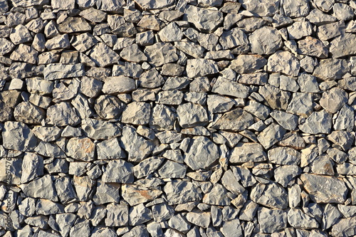 Texture of a grey granite stone wall for background
