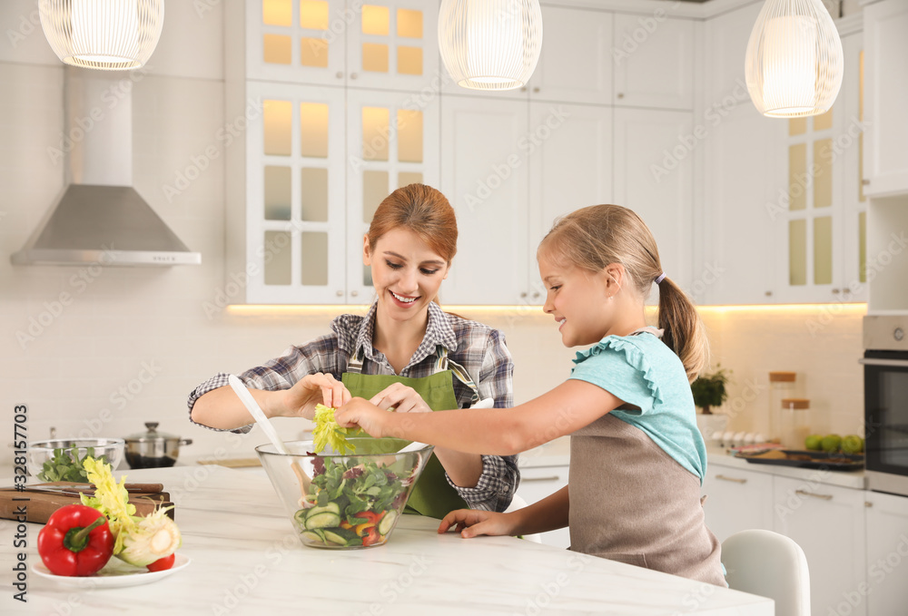 Mother and daughter cooking salad together in kitchen Mother and daughter cooking salad together in kitchen