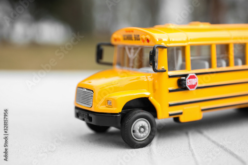 Yellow toy school bus against blurred