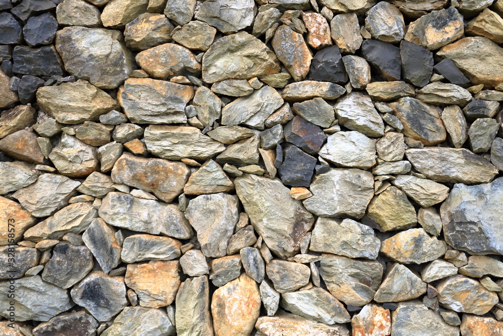 Texture of a yellow granite stone wall for background