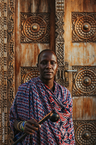 Masai men standing in front of a traditional door in old town photo