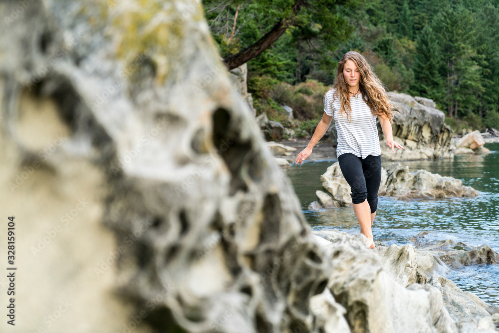 Teenage girl walking along rocky shore near Clayton Beach, WA Teenage girl walking along rocky shore near Clayton Beach, WA