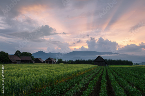 Clearing storm over a rural landscape with traditional barns. photo