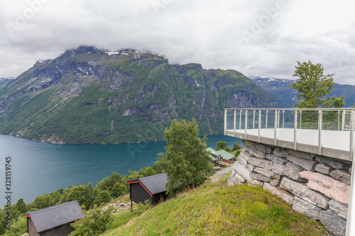 observation place with amazing view to Geiranger fjord Norway in cloudy weather, selective focus.