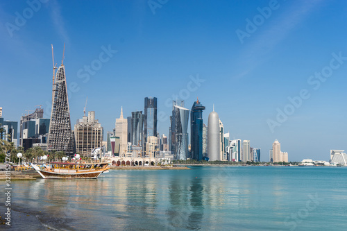 Skyscrapers in the city center with water and boat foreground of Doha  Qatar 2020.