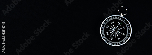 Old compass on a black background. Copy space for text or design