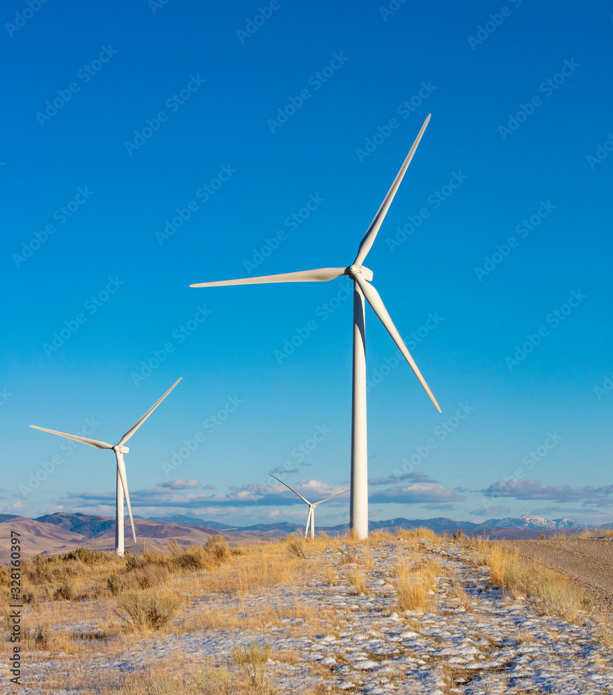 Wind turbines in a field with blue sky Wind turbines in a field with blue sky