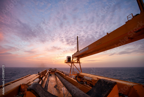 Offshore Drilling during sunset in the Gulf of Mexico photo