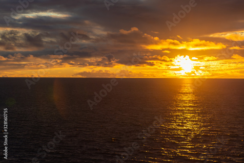 Amazing sunset with colorful clouds and dark ocean water  nature background