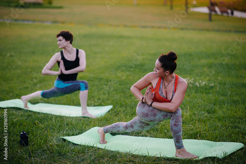 Young girls do yoga outdoors in the Park during sunset. Healthy lifestyle