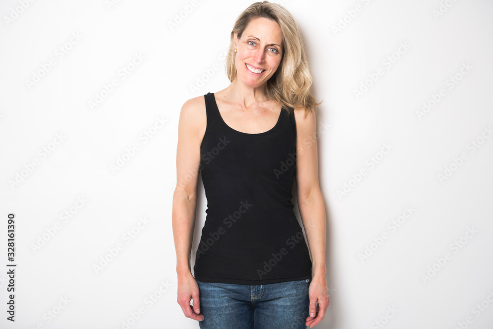 beautiful woman wearing black tank top over white studio wall. beautiful woman wearing black tank top over white studio wall.