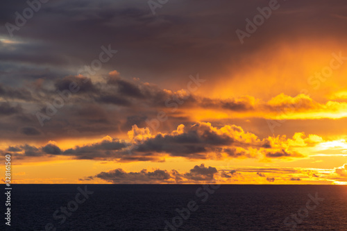 Amazing sunset with colorful clouds and dark ocean water  nature background