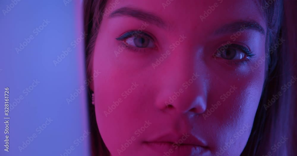 Close-up eyes Caucasian girl night neon light sensually gently looks at the camera the temptation Close-up eyes Caucasian girl night neon light sensually gently looks at the camera the temptation
