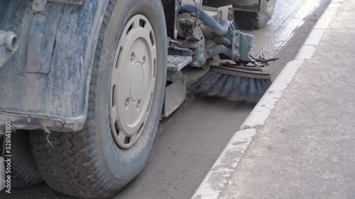 A special cleaning machine cleans the street garbage. City service. Street sweeping machine