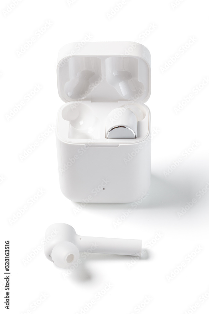 White Wireless Sport Headphones with Charging Box. Wireless in-ear Headphones for Jogging. Close Up View. Isolated on White Background. White Wireless Sport Headphones with Charging Box. Wireless in-ear Headphones for Jogging. Close Up View. Isolated on White Background.