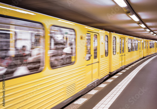 yellow subway cars go to the station