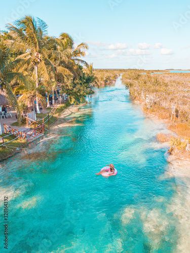 Girl navigating Bacalar Lagoon, near Cancun in Riviera Maya, Mexico