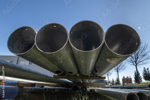 WEINFELDEN, SWITZERLAND - MARCH 1, 2020: Four industrial aluminum pipes in the factory yard photo