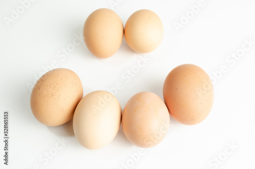 group of fresh brown chicken eggs on a white background