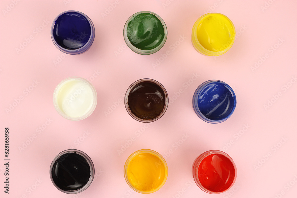 Gouache cans on a pink background Gouache cans on a pink background