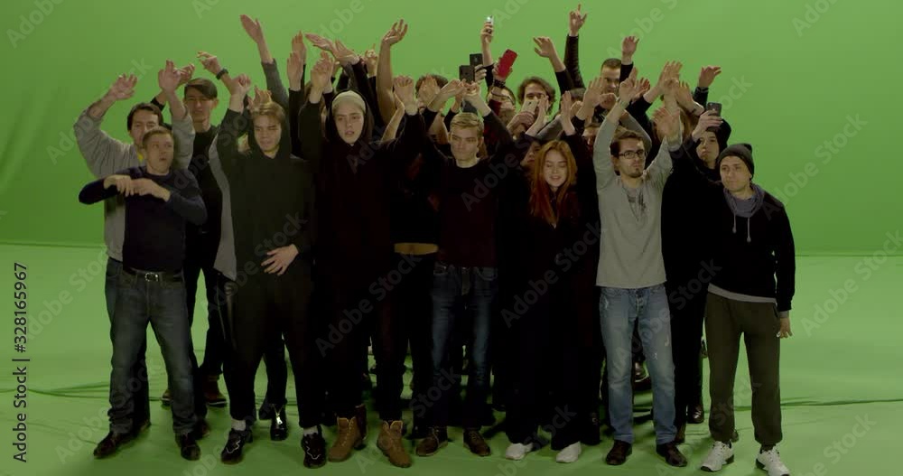 GREEN SCREEN CHROMA KEY Model released, Front view of huge crowd jumping and cheering at a concert or a show. Shot on RED Helium 8K in RAW