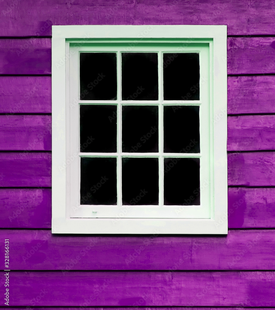 Multi pane window frame on a purple wooden building