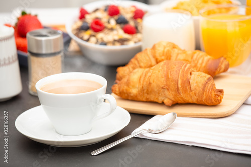 Breakfast Served in the morning with Hot black coffee and croissants Natural corn flake breakfast cereal in cups and fruit on the breakfast table every day