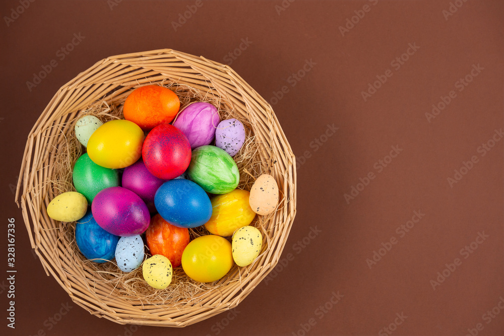 Beautiful group Easter eggs in the spring of easter day, red eggs, blue, purple and yellow in Wooden basket on the brown background Beautiful group Easter eggs in the spring of easter day, red eggs, blue, purple and yellow in Wooden basket on the brown background