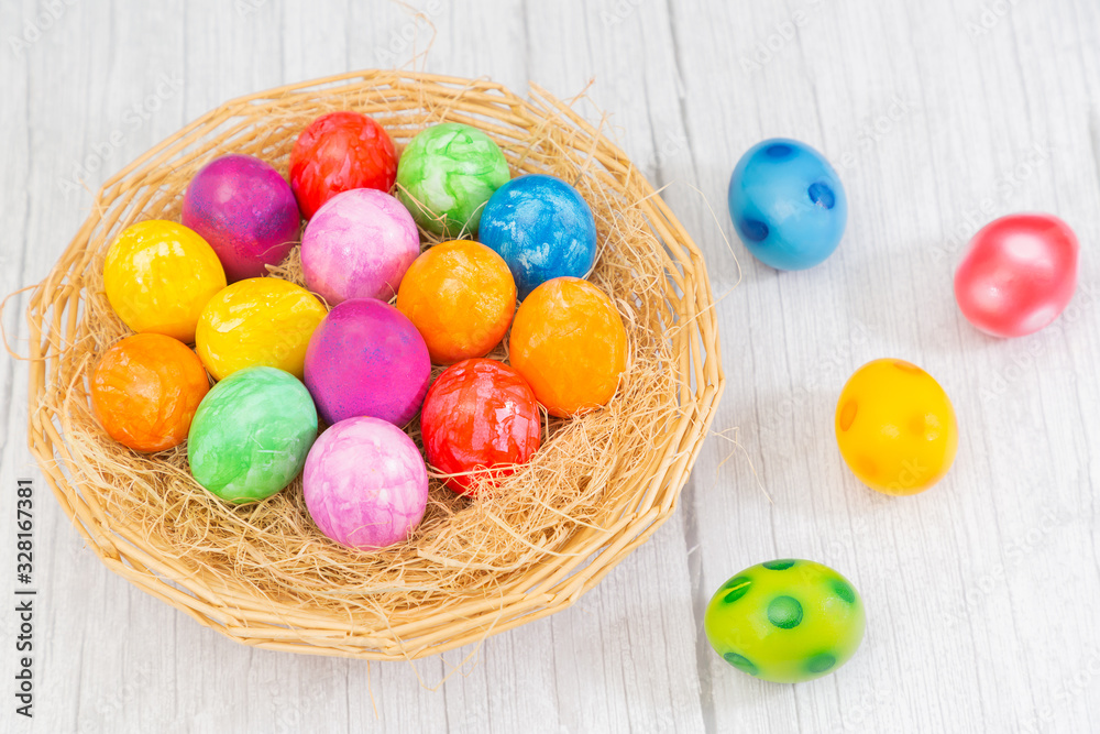 Beautiful group Easter eggs in the spring of easter day, red eggs, blue, purple and yellow in Wooden basket on the table background wood.