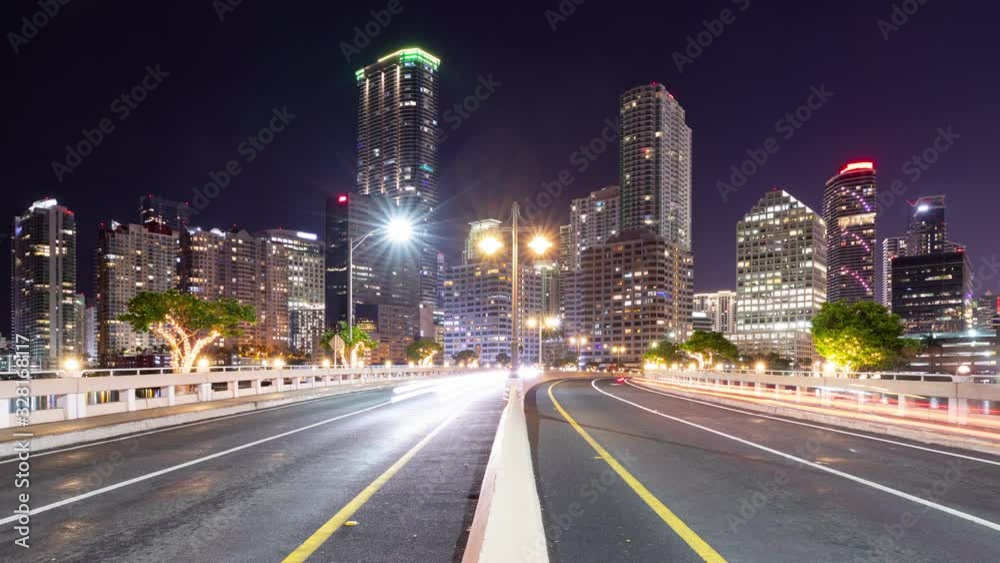 Night time lapse of traffic going over a bridge and the tall buildings of Miami Florida Night time lapse of traffic going over a bridge and the tall buildings of Miami Florida
