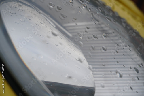 Small raindrops on headlights and body parts.