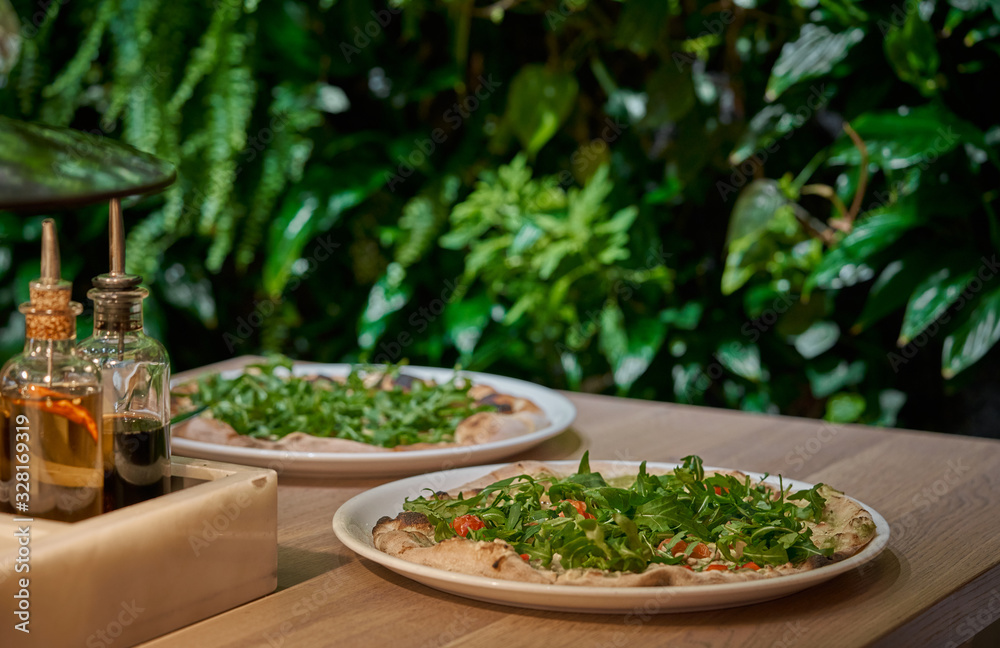 Vegan pizza with fresh arugula