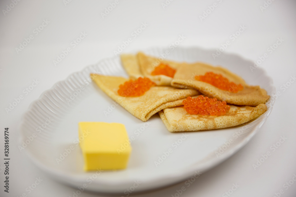 caviar with pancakes on a white plate and butter caviar with pancakes on a white plate and butter